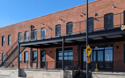 MHP BUILDING A large brick building with metal staircases and railings.