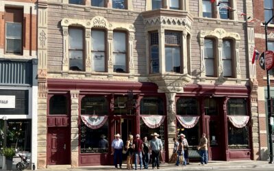 WYOMING HOME A group of people wait to cross a street in Downtown Cheyenne.