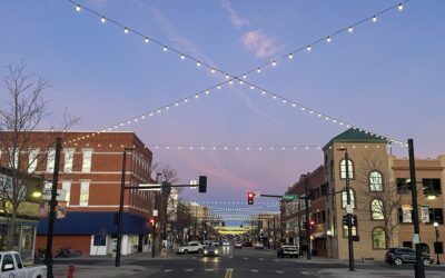 17TH-ST-LIGHTS-SUNSET Looking down 17th Street, with a colorful sunset behind criss-crossing string lights.