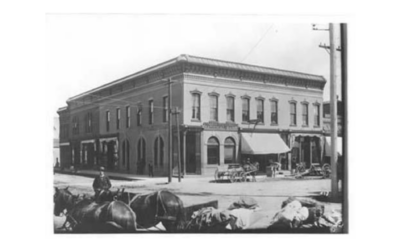 17TH-AND-CAREY-1884 Horses and carriages are shown outside a large building in a historic photo from 1884.
