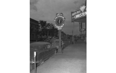 18TH-AND-CAREY A historic photo shows a street sign for Christensen Jewelry that looks like a watch.