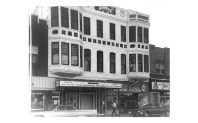 ATLAS-THEATER A historic streetscape, showing a theater with a marquee and surrounding businesses.