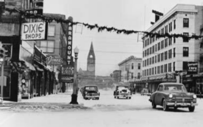 CAPITOL-AVE-SOUTH-TO-DEPOT A historic photo shows vintage cars driving down a snowy downtown street.