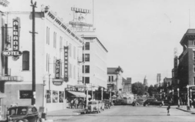 CAPITOL-NORTH-1950s A historic photo of a downtown area in the 1950s, showing vintage cars.