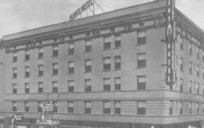 PLAINS-HOTEL A historic photo of the Plains Hotel with cars parked out front.