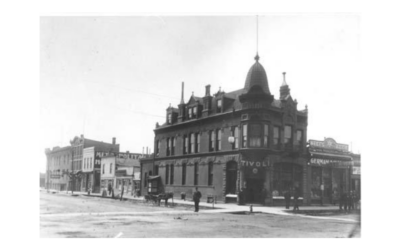 TIVOLI A historic photo of the Tivoli Building in Downtown Cheyenne, with a horse and cart outside.