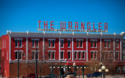 The Wrangler A side view of a large red-and-white building, topped with signage for The Wrangler.