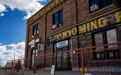 Asher Building – Side Exterior of the Asher Building, showing signage for Chronicles Distilling and CWD.