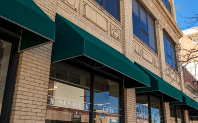 Building with Awnings Green awnings decorate a tall brick building