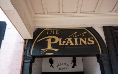 The Plains with Peacock Alley A sign for The Plains is mounted to an awning over Peacock Alley.