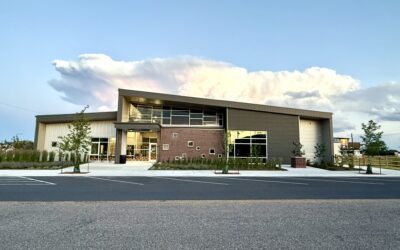 THE CHILDRENS MUSEUM: AFTER Exterior of the Cheyenne Children's Museum, with green landscaping and bronze statues out front.