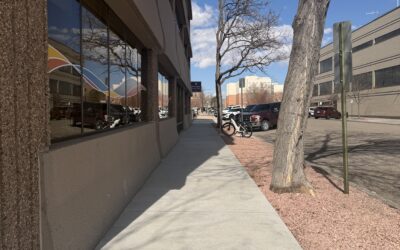 HEALTH WORKS THOMES A sidewalk stretches out next to a two-story building.